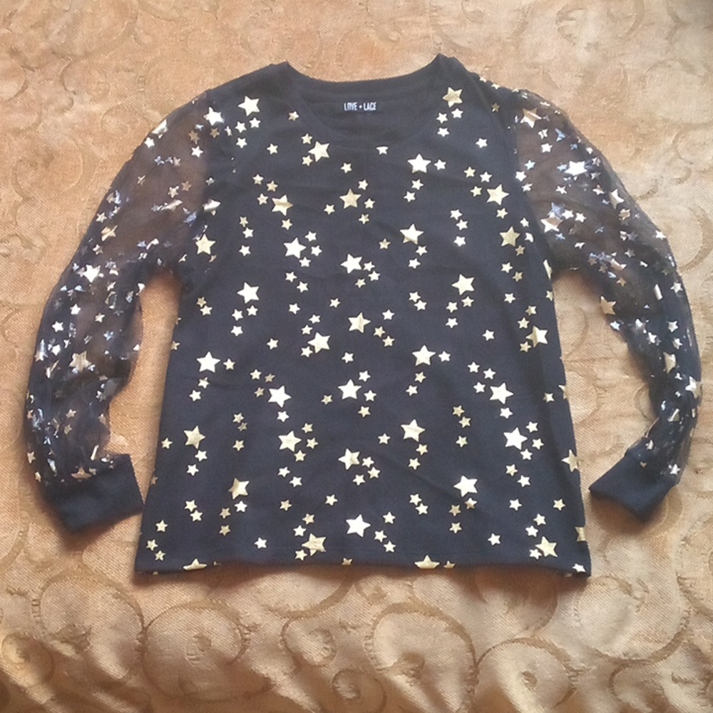 Love + Lace black top with mesh puff sleeves and metallic gold stars